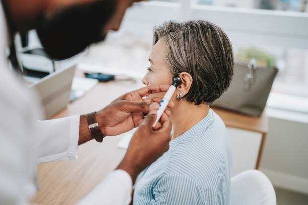Doctor analyzing human ear