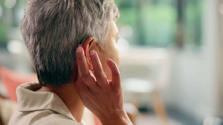 Senior woman, consultation and happy with hearing aid for audiology, restore sound or healthcare. Clinic checkup, old person with disability and cochlear implant device for tinnitus or acoustic tumor